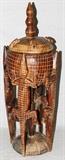 Lot#18, AFRICAN DOGON CARVED MEDICINE POT, H 55" W 16", MALI,Raised on a footed pole base, with carved crocodile figures along the sides; featuring a bulbous form lidded pot. The lid is decorated with bowing figures carved in relief, and a turned finial at the center. Measures H. 55" x 16". Property from the Henry Stallings II Collection, Detroit, MI.