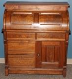 Lot#201, WALNUT CYLINDER ROLL TOP DESK, H 44", W 39", D 22"opening the top reveals a slide out desk top with green felt top, center cubicle flanked by six pigeon holes three per side all having green felt,  above two small narrow drawers. Below the desk top are two half width drawers which are accessible with the top closed. Two deep half width drawers on the left and one cabinet on the right side with paneled door with brass pull. Fluted corner posts. Mounted on casters.