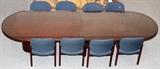 Lot#310, CHERRY WOOD CONFERENCE TABLE AND NINE  UPHOLSTERED CHAIRS, H 29" L 145" D 48"contemporary design having an Oval top with a glass top and pedestal base with eight upholstered side chairs.