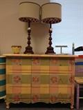fun loving colors on this  painted chest  and a pair of neutral lamps, shades  lined in a rusty red and sand fabric
