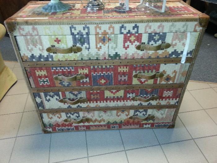 chest of drawers, meticulously covered  with a drury rug