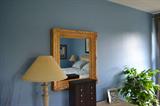 Golden framed mirror, pictured with lamp