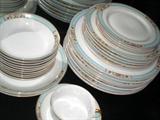 Delicate floral pattern on blue rimmed china. Large set available.
