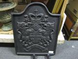Fire shield. A Great Coat of Arms to put in front of the fire to diffuse the heat.