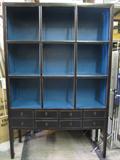 Large Dark Cabinet with Blue cubbies Approximately 7'6" TALL by 53" wide. Has 8 drawers and lots of display room