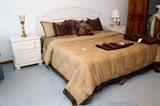 King size paneled bed with luxurious cheetah bedding, matching night stands