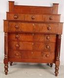 116 - Mahogany empire 7 drawer chest with chimney back splash upon turned legs, 56in. T, 42in. W, 21in. D.
