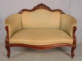 118 - Walnut Victorian small loveseat with carved crown and green upholstery, ca. 1860, 34in. T, 50in. W, 18in. D.