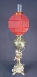 146 - Oil lamp that has been electrified, with cherubs and red satin shade, 36in. T.
