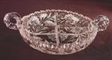 259 - Brilliant cut glass divider bowl with handles, 3in . T, 11in. From handle to handle, 8in. Dia.
