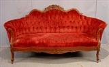 321 - Mahogany Victorian style sofa with roses carved in crown, maroon upholstery.