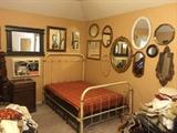 antique bed with mirrors around. not a mattress there-- just covered up tables