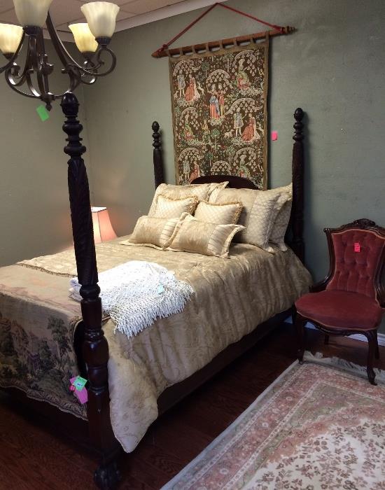 Antique double bed and tapestry.