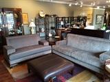Michael Amini contemporary sofa and loveseat, square leather ottoman, lamps, rug.
