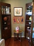 Mahogany Heredon corner curio cabinets, brass tray with stand, ceramics, and art.