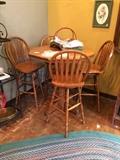 Oak pub table with 4 stools, and vintage braided rug.
