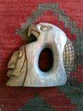 Hand carved stone eagle & face sculpture