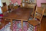 REPRODUCTION HARVEST TABLE AND 6 PRESS BACK OAK CHAIRS