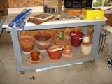Garage work bench with assortment of flower pots