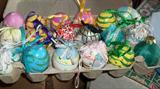 Many trays of painted eggs.