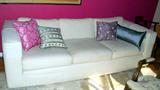 Three seater white sofa.