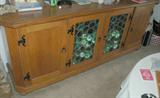 Vintage solid wood sideboard with leaded glass doors. Matches barrel chair dining room set and hanging wagon wheel chandelier.