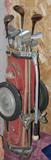 Vintage golf clubs and cart. One set is left-handed.