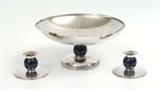 Lot 1002: 3 PIECE TIFFANY STERLING CENTER BOWL & GARNITURE: Mid 20th century production, 3 pieces total, each with blue enamel ball body. To include 1) Center bowl, numbered 22125R, 5 7/8'' h.x 12 3/8'' dia. 2-3) Pair garniture candlestands, numbered 22964P, 2 3/4'' h. x 4 5/8'' dia. Each pieces monogrammed ''W''. Est. $3000/5000**
CONDITION: Scratches to silver, crazing to enamel. Signs of use.