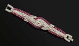 Lot 1038:  ART DECO PLATINUM DIAMOND AND RUBY BRACELET CA. 1930'S: Quintessential design and style in this platinum bracelet. 54 round shaped native cut rubies total approx. 18.90 Ct., average VS clarity and 3-4 saturation. Diamonds include 7 marquise brilliant 46 baguette and 302 round full cut all totaling approx. 14 Ct., averaging VS-SI in clarity and G-H-I color. Rubies are prong set, diamonds are bead, channel and prong set. Note the fine detailing of the clasp also covered in diamonds. Length 6 5/8''. Weight 58.6 grams. Sold with current Atlanta Gemological GIA graduate's appraisal for $62,550. Est. $45000/62550**