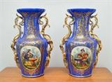Lot 1319: PAIR OLD PARIS PORCELAIN VASES: Each with hand painted Orientalist at tea in garden scene, blue ground with gilt decoration, applied foliate handles. Unmarked, felt applied to bottoms. Overall measures 16 3/4'' h. x 10 1/2''.
CONDITION: Loss of gilt, firing flaw or crack at rim of one. 