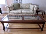 Solid wood coffee table, two beveled glass inserts, caned bottom shelf (needs to be reattached)