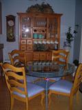 the owner is taking the table base but not the glass or chairs! There is a table that actually matches the chairs and hutch!
