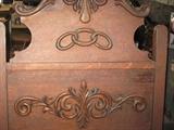 close up of carved Odd Fellows Lodge Emblem on throne chair.