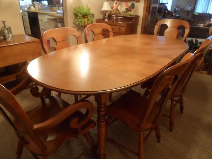 Dining room table has 2 leaves inserted. Matches hutch.
