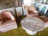 Traditonal Salmon Velveteen Swivel Rock Arm Chairs with French Provencial Marble Swirl Salmon White Cocktail table.Many Various Signed Prints Behind Chairs