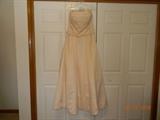 Strapless, champagne color dress. Beaded and rhinestone.100% polyester. Zippered back. Size 14. No obvious flaws.
