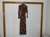 Retro early 1970’s. Black with tan and rust floral pattern, front slit halter dress and
matching jacket. Appears size small.