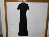 Black knit dress with high neck & low back . This dress is short sleeved & stretchy. Appears size small. It has been taken in at waist but can be let out up to 3 inches.
There is a small hole near neck. Rehemming is necessary.