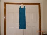 Turquoise blue tank dress. Label previously removed. Side split.
Appears to be polyester material.