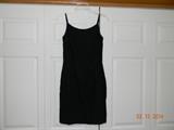 “Anne Fogerty” Little black dress with metal zipper. Spaghetti straps.
Nicely fitted. Shorter length. Lined. Linen look fabric. Size appears to be small.