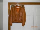 Genuine, soft leather, “M. Julian” Jacket. Tag reads, “ Size 40.” (European?)
Attached hood with draw string and faux fur. Jacket is lined.
It has snap outer pockets and one interior pocket.