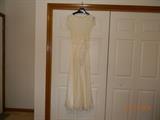 “Night Way Collections” Ivory evening gown with lace covered top. Short sleeves.
Polyester/ Nylon. Size 4.