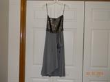 “Mustard Seed” Gray and silver stretchy sequin top dress with drop ruffle
down to hem. Beautiful condition. Size 11-12.