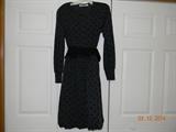“Chetta B.” Dark gray with raised black polka dot dress. Long sleeves. Cuffed.
Dress has a black leather belt. Bubble style skirt. Front zipper with snap closure.
Feels like cotton. Size 6.
