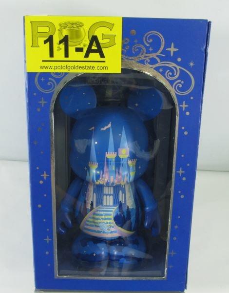 Lot#:	11a
Description:	Disney 9" Cinderella's Castle Vinylmation LE MIB
Beautiful 9" Jumbo Disney "Cinderella the Clock Strikes Twelve" Vinylmation figure with Cinderella Castle design / pattern. The figure has the classic Mickey Mouse Vinylmation shape. Figure designed after the classic 1950's Walt Disney film "Cinderella". The castle is centered on this figure complete with the iconic glass slipper sitting on the front steps. Released for the 50th anniversary of the movie "Cinderella", sold in Disney stores. Brand new and are unopened in original box. From the Disney Parks series #9 and are Limited Edition of 1500. 
From Wikipedia: "Vinylmation is a brand of 1.5", 3", and 9" vinyl collectibles sold at Disney theme parks, select Disney Stores, and the online Disney Store. The name Vinylmation is a combination of the word Animation and Vinyl. The figures are all shaped like Mickey Mouse but have different themed markings, colors, and patterns. Vinylmation was first introduced in July 2