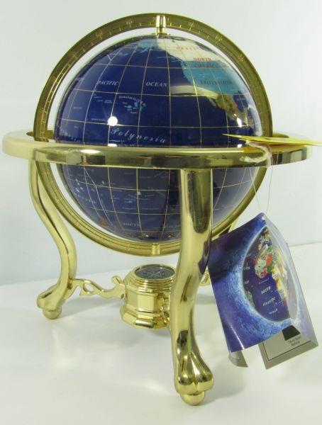 Lot#:	44
Description:	Inlaid Gemstone Globe 14" Tall w/ Brass Stand
Beautiful Inlaid “Gemstones of the World” Globe made from natural gemstones. This magnificent decorative 3 dimensional model of the Earth is beautifully hand-crafted with semi precious stones that have been artistically carved into the shape of each representative country and continent. Lapis is used for the water. Set in a large brass stand with cariole legs that come together in the center with a compass. In excellent condition with original tags. Contains, Lapis, Mother of Pearl, Jasper, Unakite, Lilac, Jade, Tigerish, Turquoise, Aventurine, Marble, Granite, and more. Original tag still affixed. Measures 14” tall x 13” in diameter.
Tag Word: terrestrial, geographical, geology, mineral, gemstone
