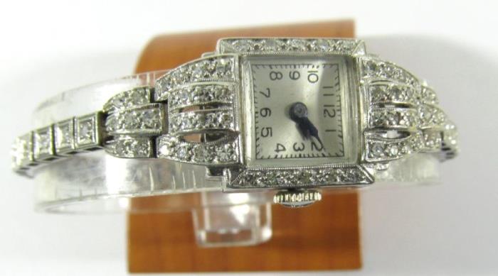 Lot#:	250
Description:	Jewelry Longines Ladies Plat 17 Jewel Wrist Watch
Stunning vintage platinum Longines ladies wrist watch. Link style band is accented with several round diamonds. Band has lovely Art Deco style design. Inside marked "Longines Watch Co. Swiss 17 jewel", case marked 10% Irid Plat". Watch measures: 6.75" long, total weight: 16.4 dwt. 
From wikipedia: "Longines is a luxury watches house based in Saint-Imier, Switzerland. Founded by Auguste Agassiz in 1832, the company is owned by the Swatch Group. Its winged hourglass logo is the oldest registered for a watchmaker."