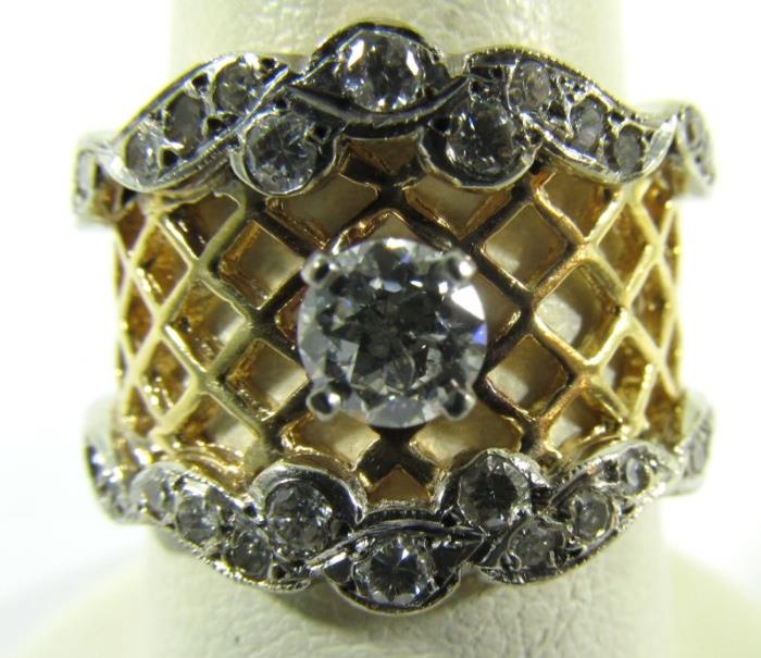 Lot#:	390
Description:	Jewelry 14kt Yellow Gold Diamond Cocktail Ring
Gorgeous 14kt yellow gold cocktail ring featuring a lovely lattice work cut out design. Featuring a large round prong set diamond stone. Band is accented with smaller round diamonds. Marked "14k", ring size: 6.75. 
Total weight: 4.3 dwt. 