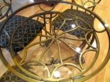 Top view of wrought iron spider web design table base to Ornate Cafe Set...Set includes Glass & Metal Round Table with Glass Top and wrought iron base with spider web design and nicely scrolled legs, four (4) matching wrought iron chairs with spider design backs and cushion seats