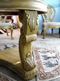Side view of the pedestal base to Continental Style glass & wood dining table...nicely scrolled legs with beautifully carved accents. The chair in the background is one of four matching Continental Style Dining Side Chairs for the dining set......with beautifully carved backs, and legs, ivory crackle finish, and cotton ivory and beige texture upholstered seats;